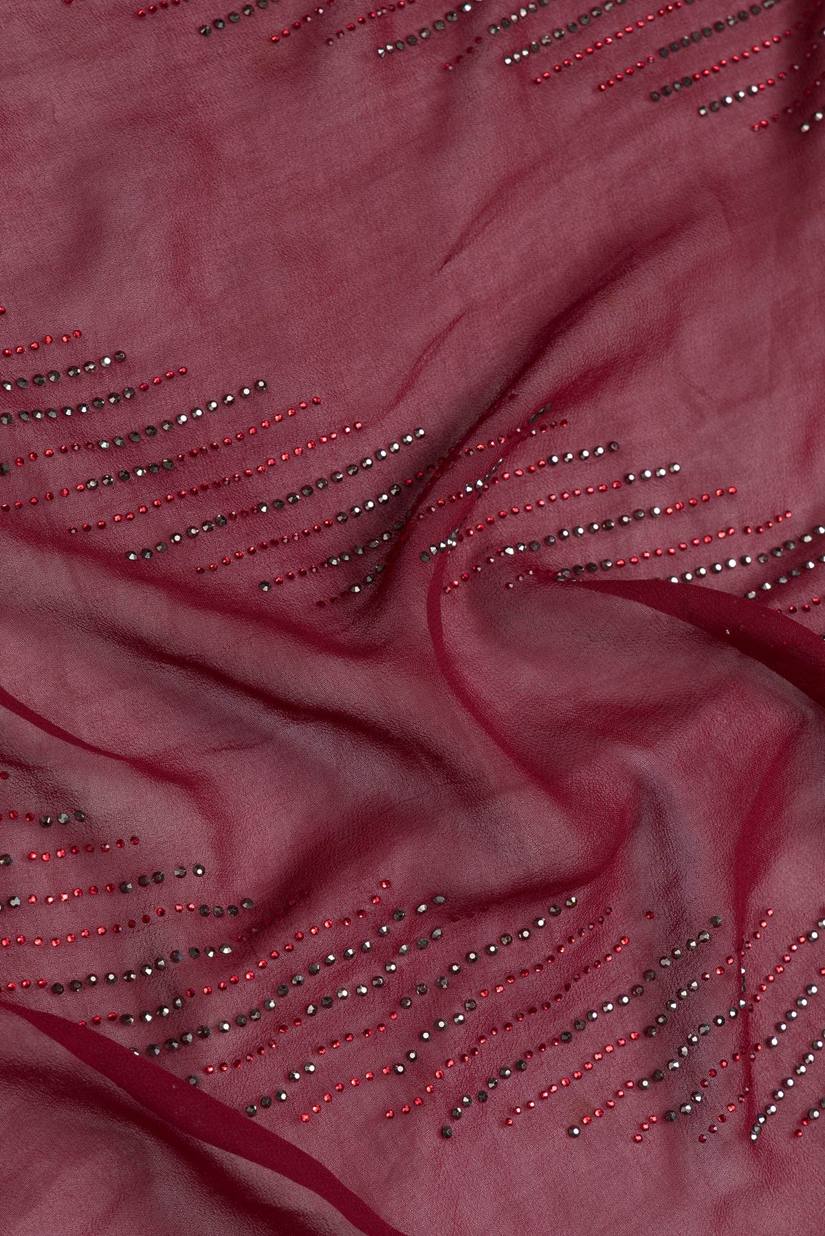 Close up of Maroon Dual Tone Georgette Saree with Embroidery on the body and Embroidery Border.  displaying folds