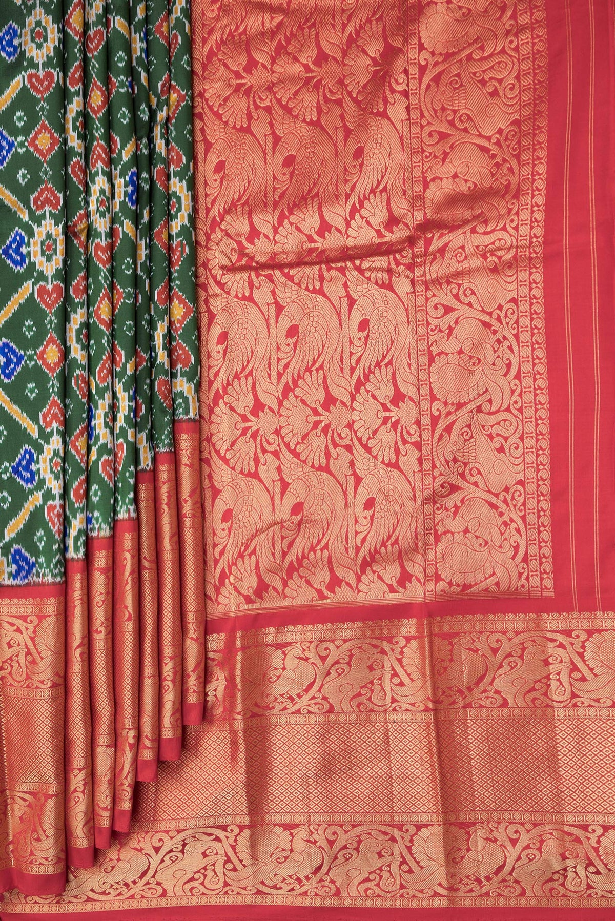 Pleats and pallu of Bottle Green Dual Tone Kanchipuram Silk Saree with Ikat Print on the body and Zari Border. 