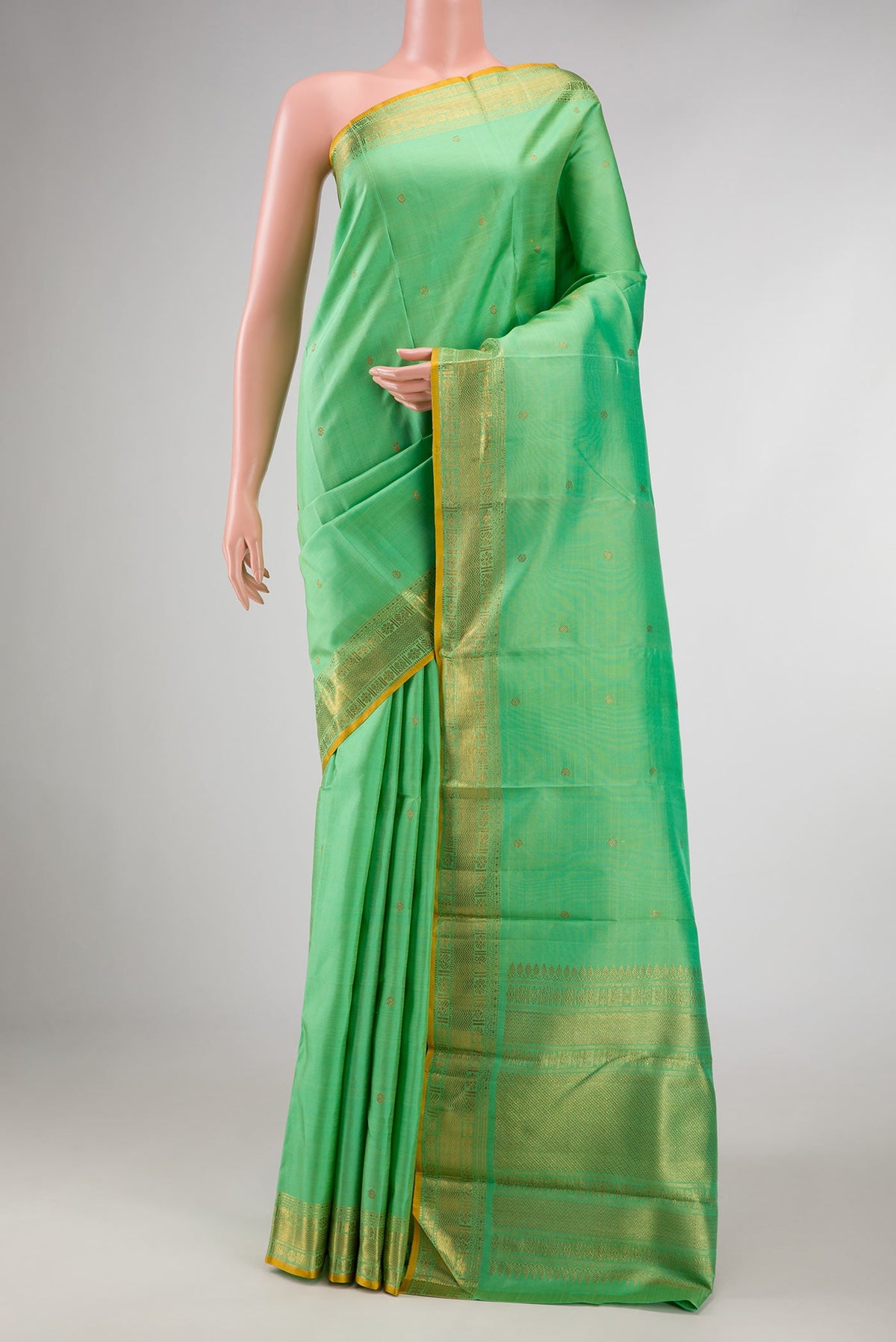 Sea Green Dual Tone Kanchipuram Silk Saree with Zari Butta on the body and Zari Border displayed on a mannequin
