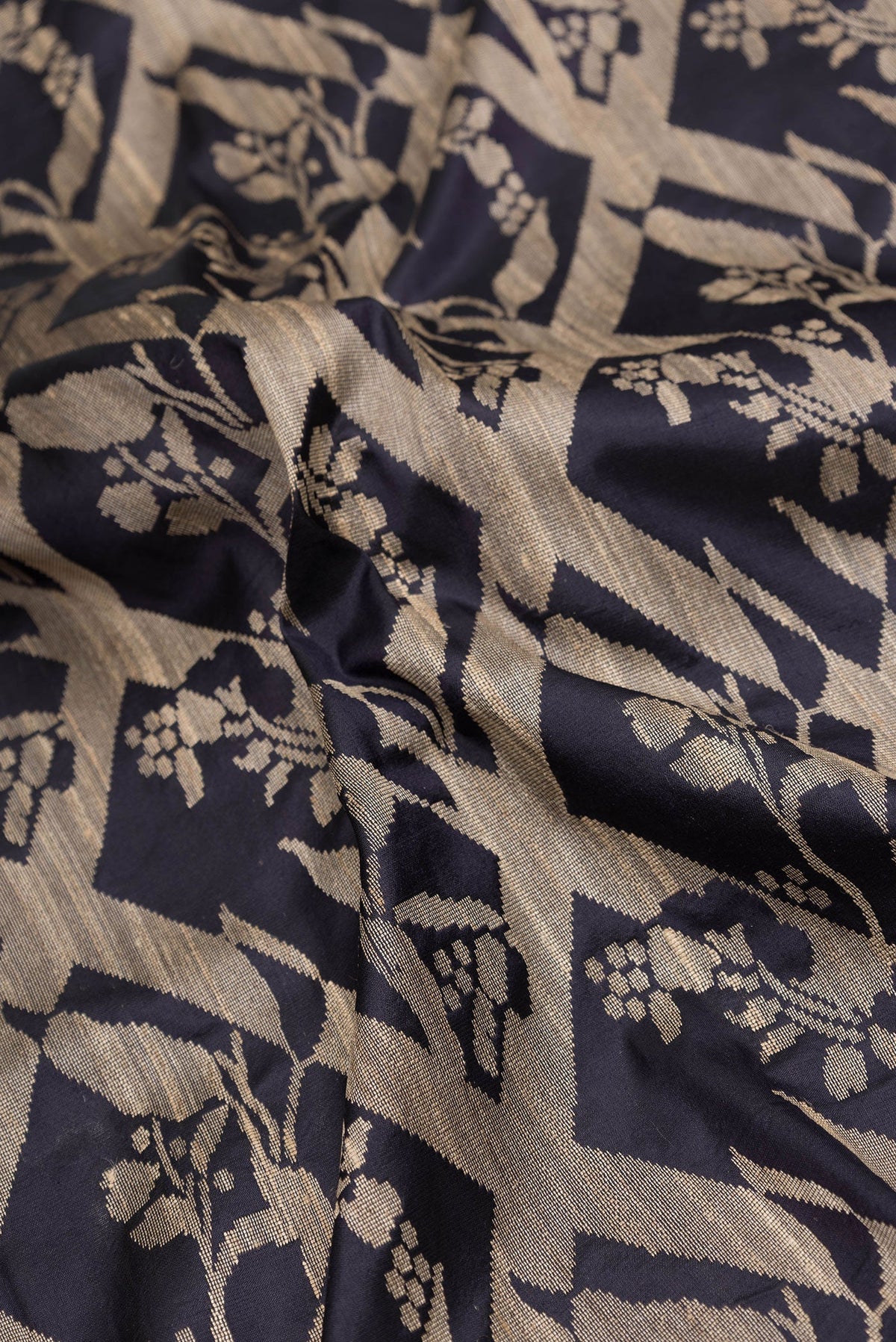 Close up of Navy Blue Dual Tone Tussar Silk Saree with Jacquard design on the body and Plain Border.  displaying folds