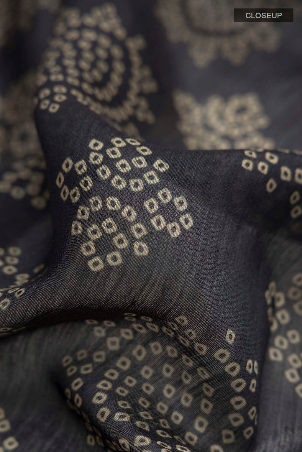 Close up of Black Bhagalpuri Tussar Silk Saree with Printed design on the body and Zari Border displaying folds