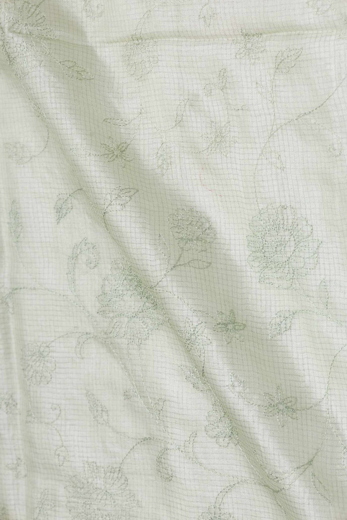 Close up of Pista Green Dual Tone Tussar Saree with Embroidery on the body and Embroidery Border displaying folds