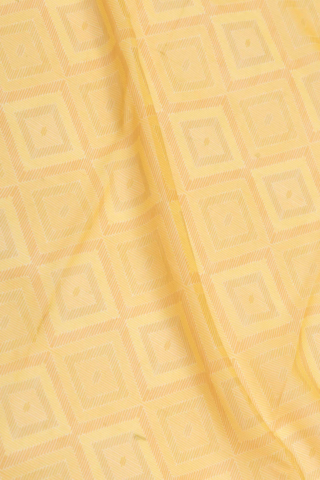 Close up of Yellow Dual Tone Georgette Saree with Printed design on the body and Zari Border displaying folds