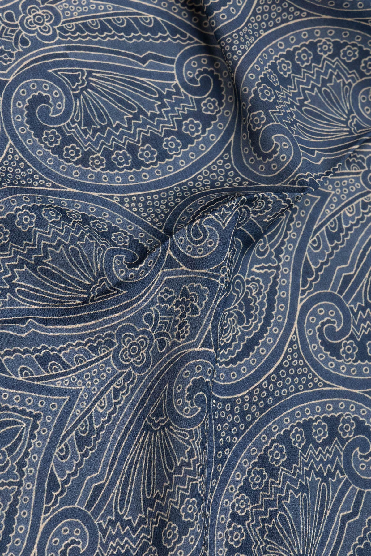 Close up of Grey Mysore Crepe Saree with Printed design on the body and Zari Border.  displaying folds