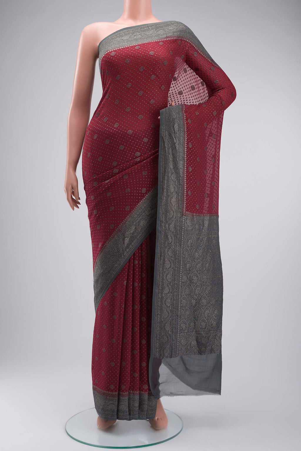 Maroon Banarasi Georgette Saree with Zari Butta on the body and Zari Border displayed on a mannequin
