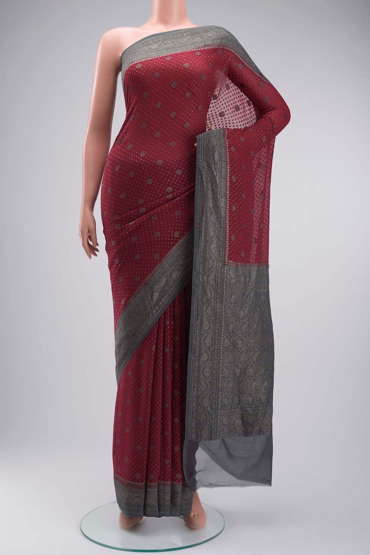 Maroon Banarasi Georgette Saree with Zari Butta on the body and Zari Border displayed on a mannequin