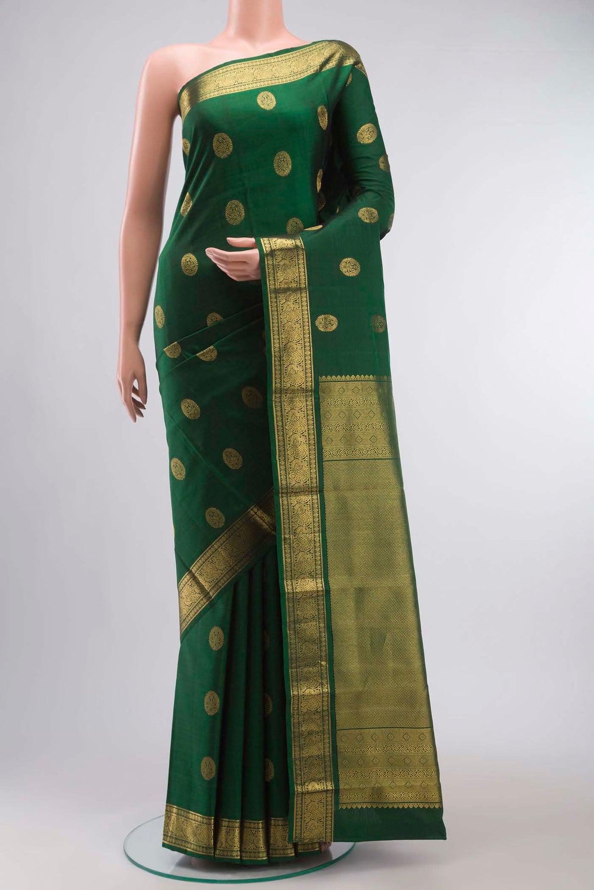 Green Kanchipuram Silk Saree with Zari Butta on the body and Zari Border displayed on a mannequin