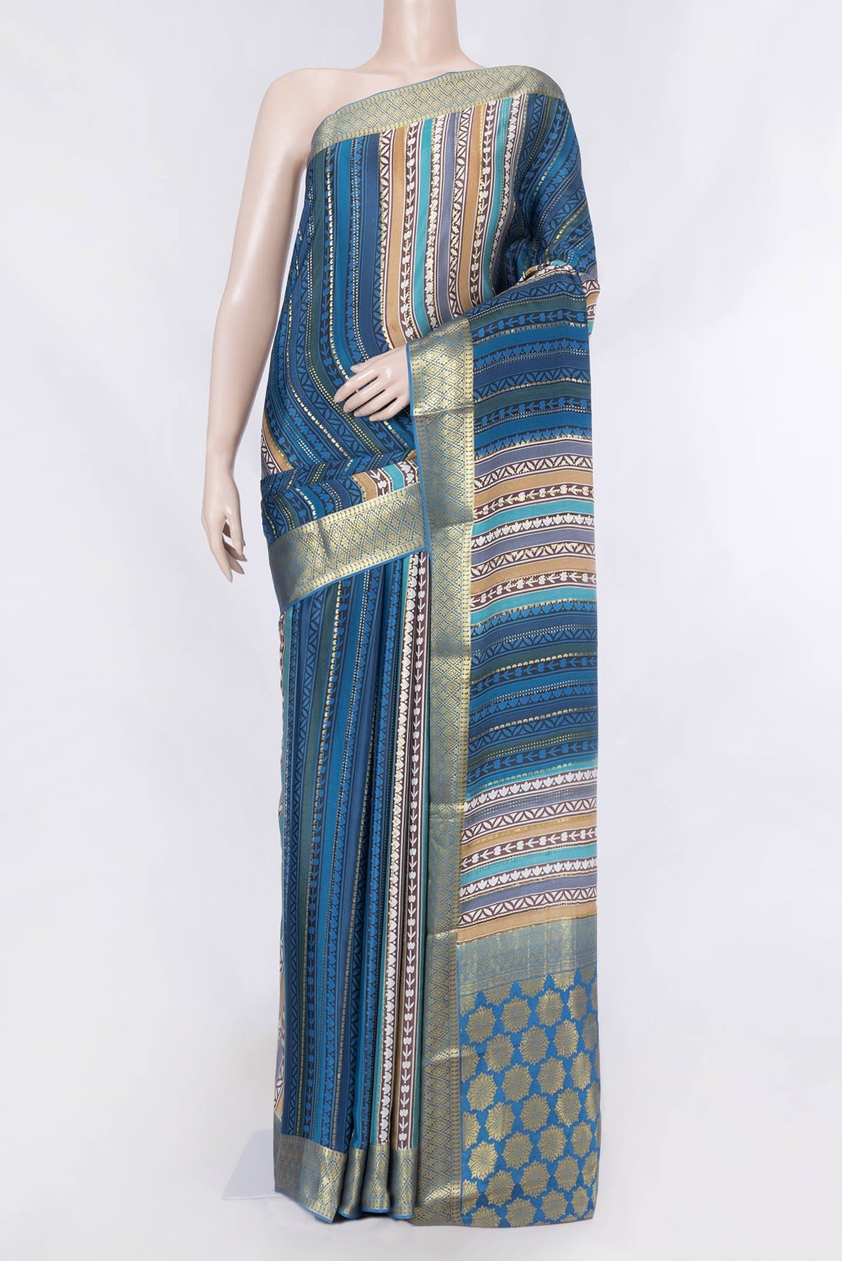 Blue , Brown and Grey Color Mysore Crepe Saree with Printed design on the body and Zari Border displayed on a mannequin