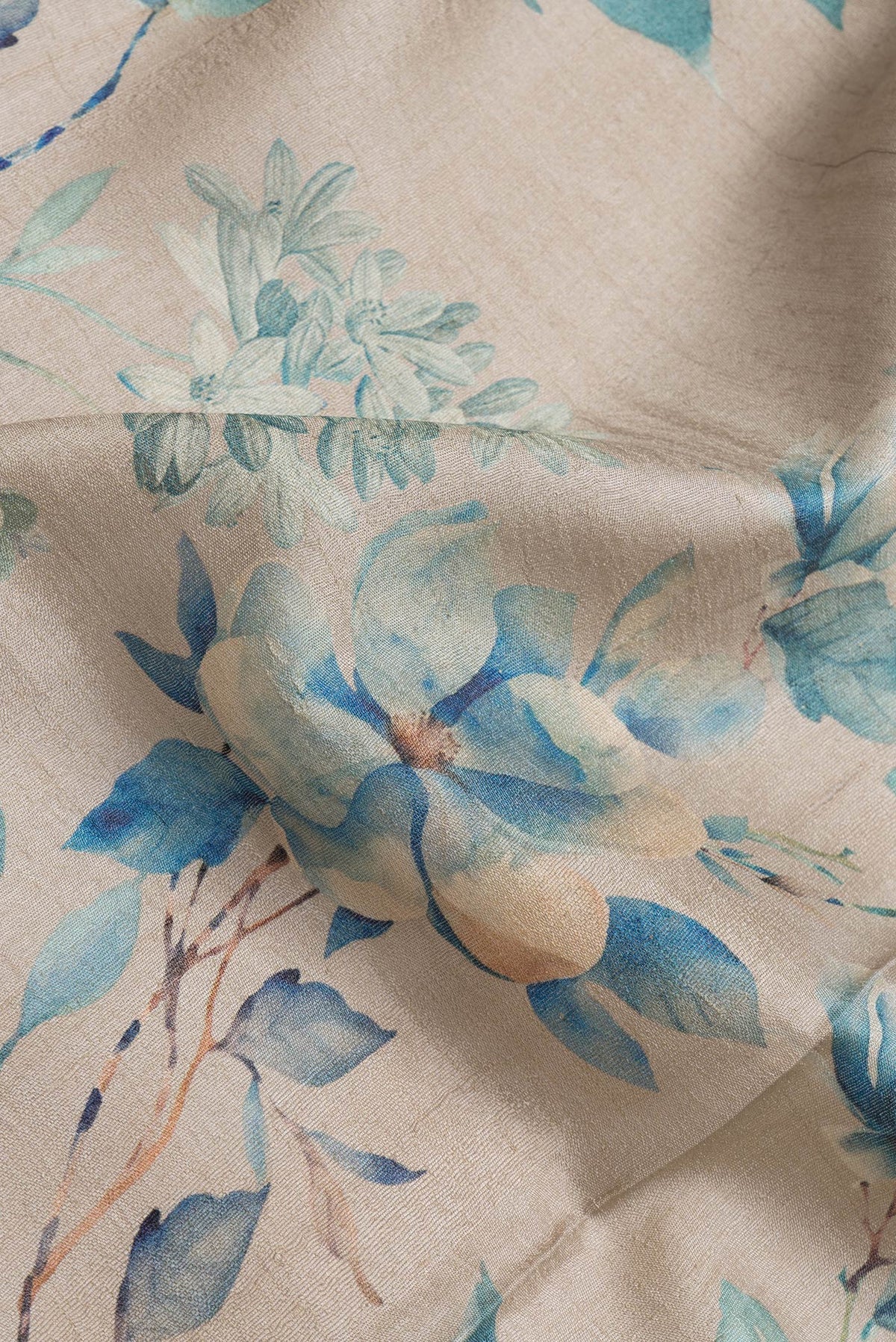 Close up of Beige Dual Tone Tussar Silk Saree with Printed design on the body and Zari Border.  displaying folds