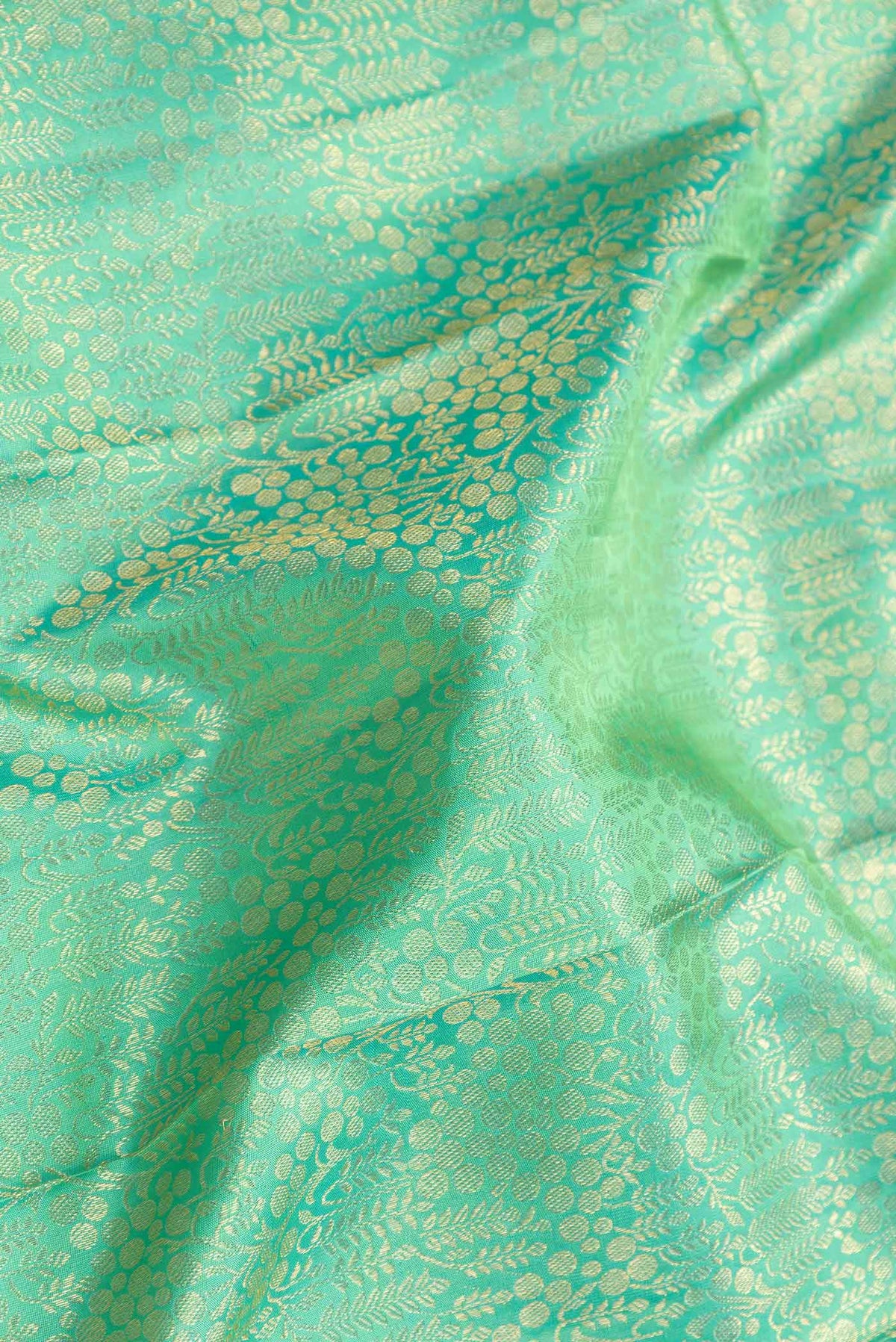Close up of Sea Green Dual Tone Kanchipuram Silk Saree with Zari Brocade on the body and Zari Border displaying folds