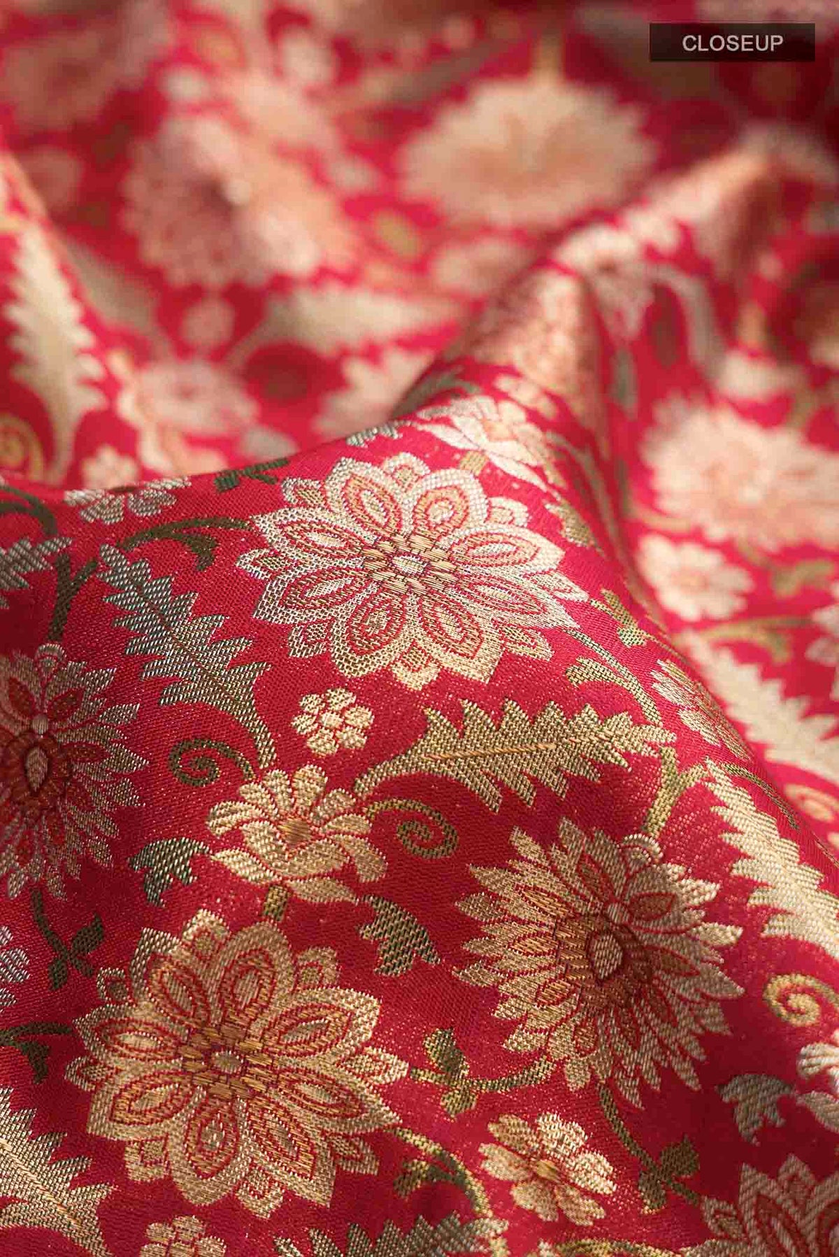 Close up of Red Kanchipuram Silk Saree with Zari Brocade on the body and Zari Border displaying folds