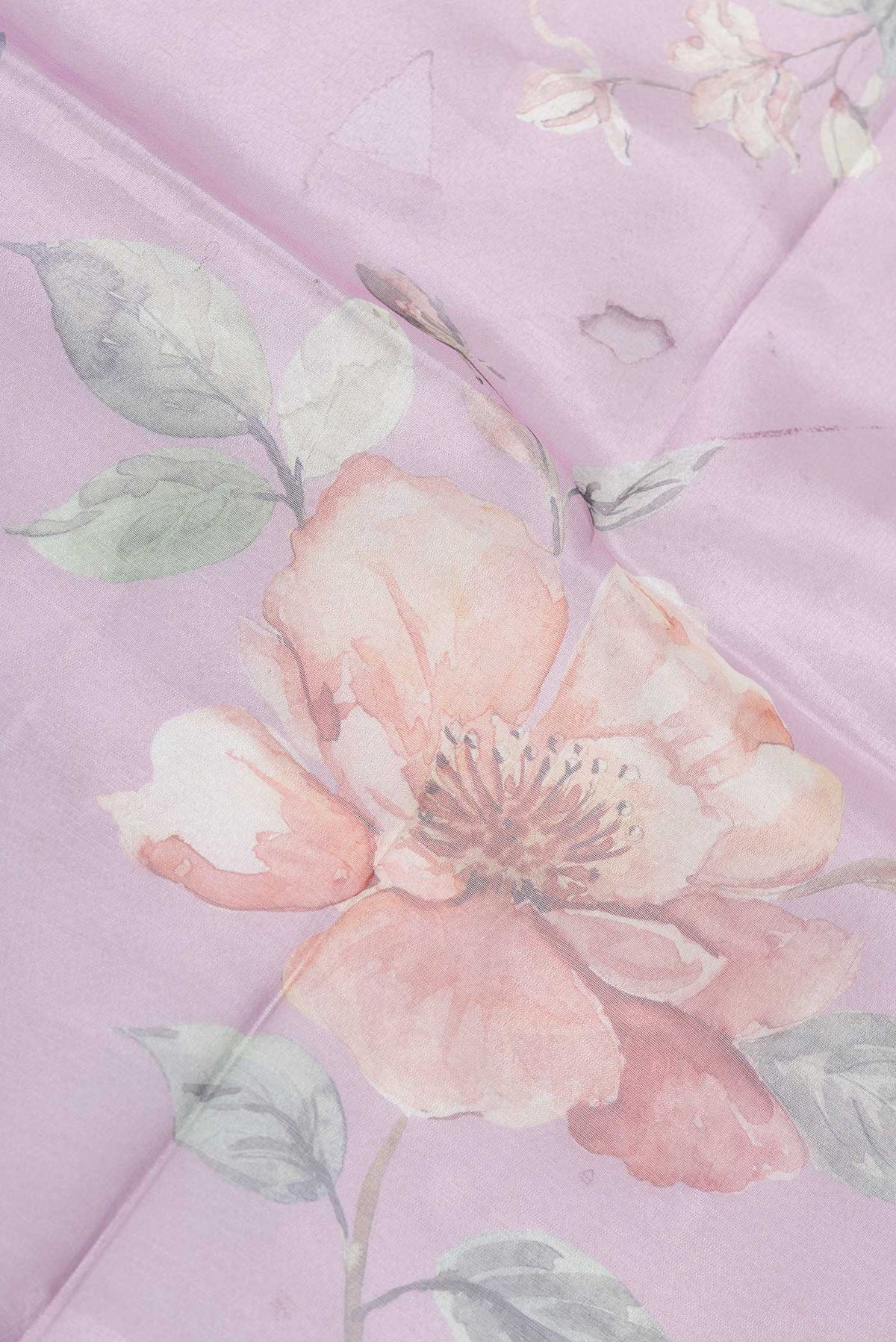 Close up of Lavender Dual Tone Tissue Silk SareePrinted design on the body and Embroidery Border displaying folds