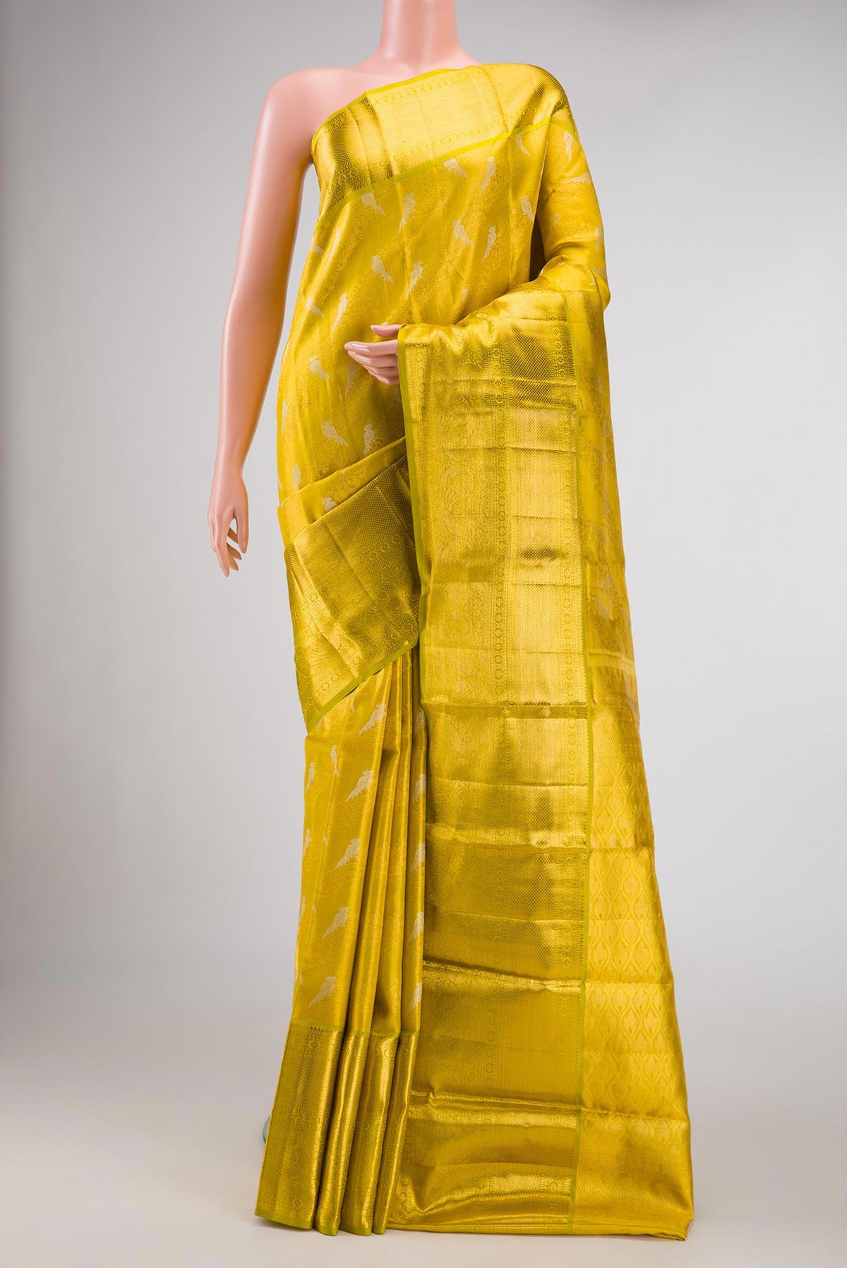 Green Dual Tone Kanchipuram Tissue Silk Saree with Zari Brocade on the body and Zari Border.  displayed on a mannequin