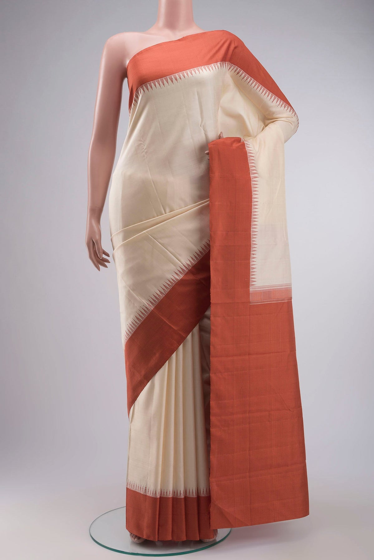 Cream Kanchipuram Silk Saree with Plain Body and Temple Border displayed on a mannequin