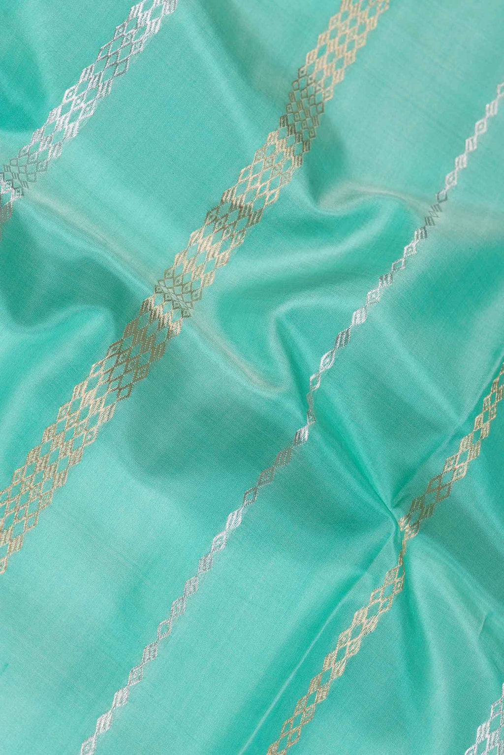 Close up of Sea Green Dual Tone Banarasi Silk Saree with Stripes on the body and Zari Border.  displaying folds