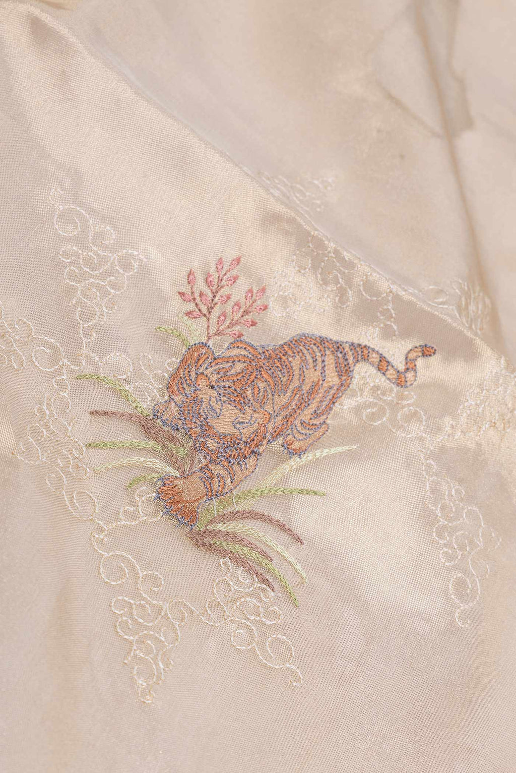Close up of Gold Dual Tone Organza Silk Saree with Embroidery on the body and Embroidery Border displaying folds