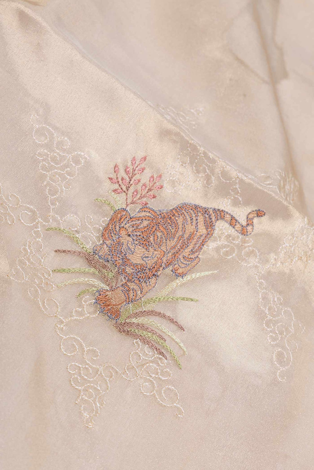 Close up of Gold Dual Tone Organza Silk Saree with Embroidery on the body and Embroidery Border displaying folds