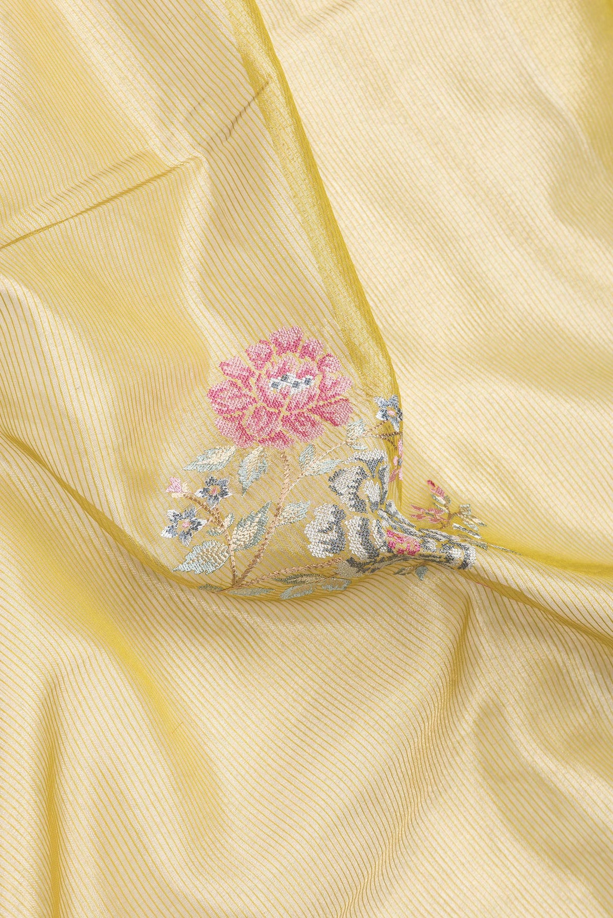Close up of Mehandi Green Dual Tone Organza Silk Saree with Embroidery on the body and Zari And Thread Border.  displaying folds