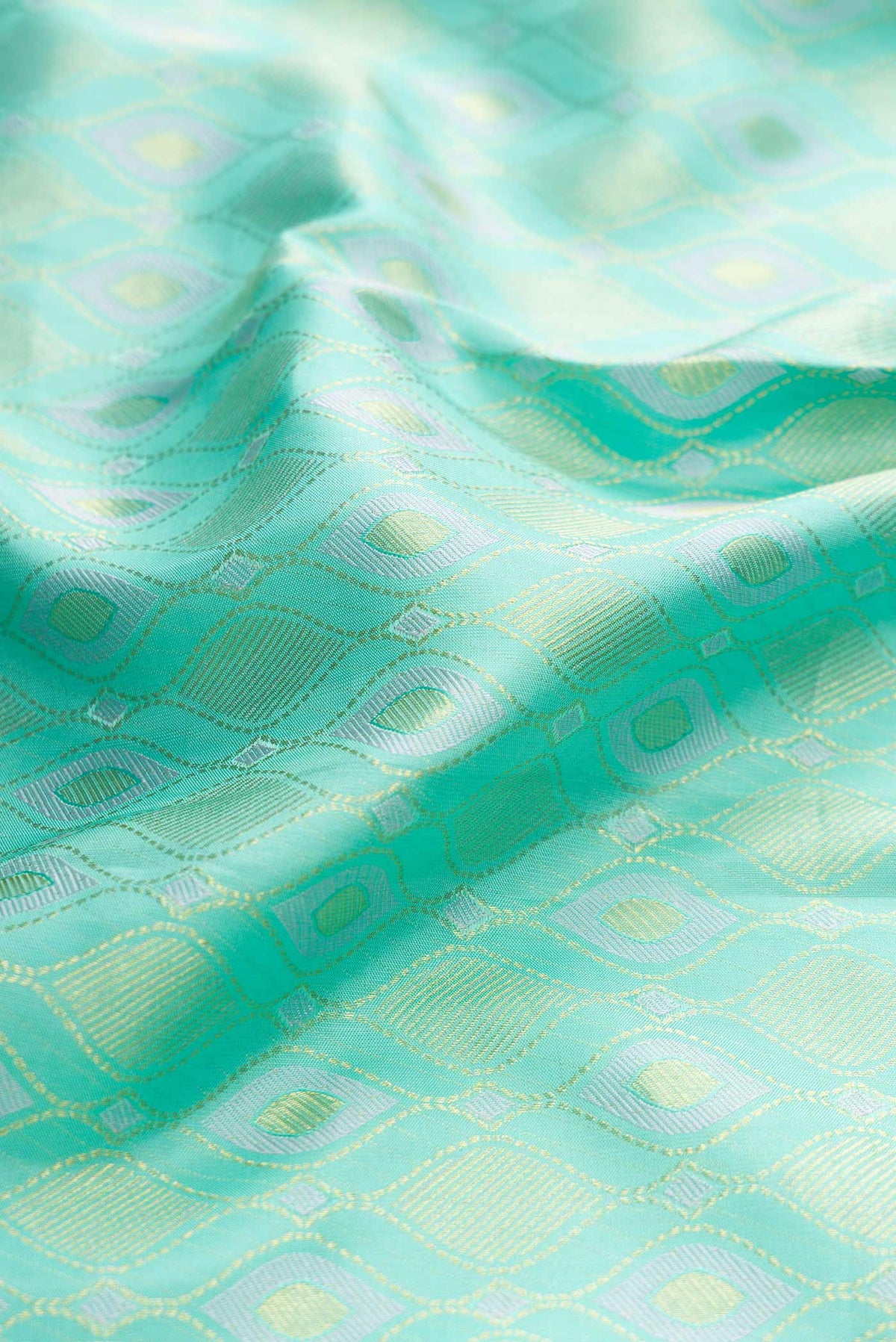 Close up of Sea Green Dual Tone Kanchipuram Silk Saree with Zari Brocade on the body and Zari Border displaying folds