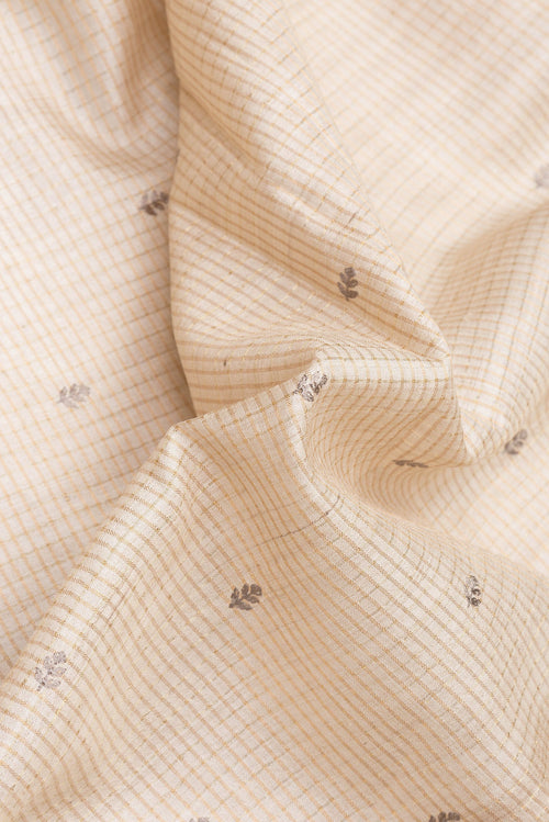 Close up of Beige Dual Tone Tussar Silk Saree with Checked design on the body and Embroidery Border.  displaying folds