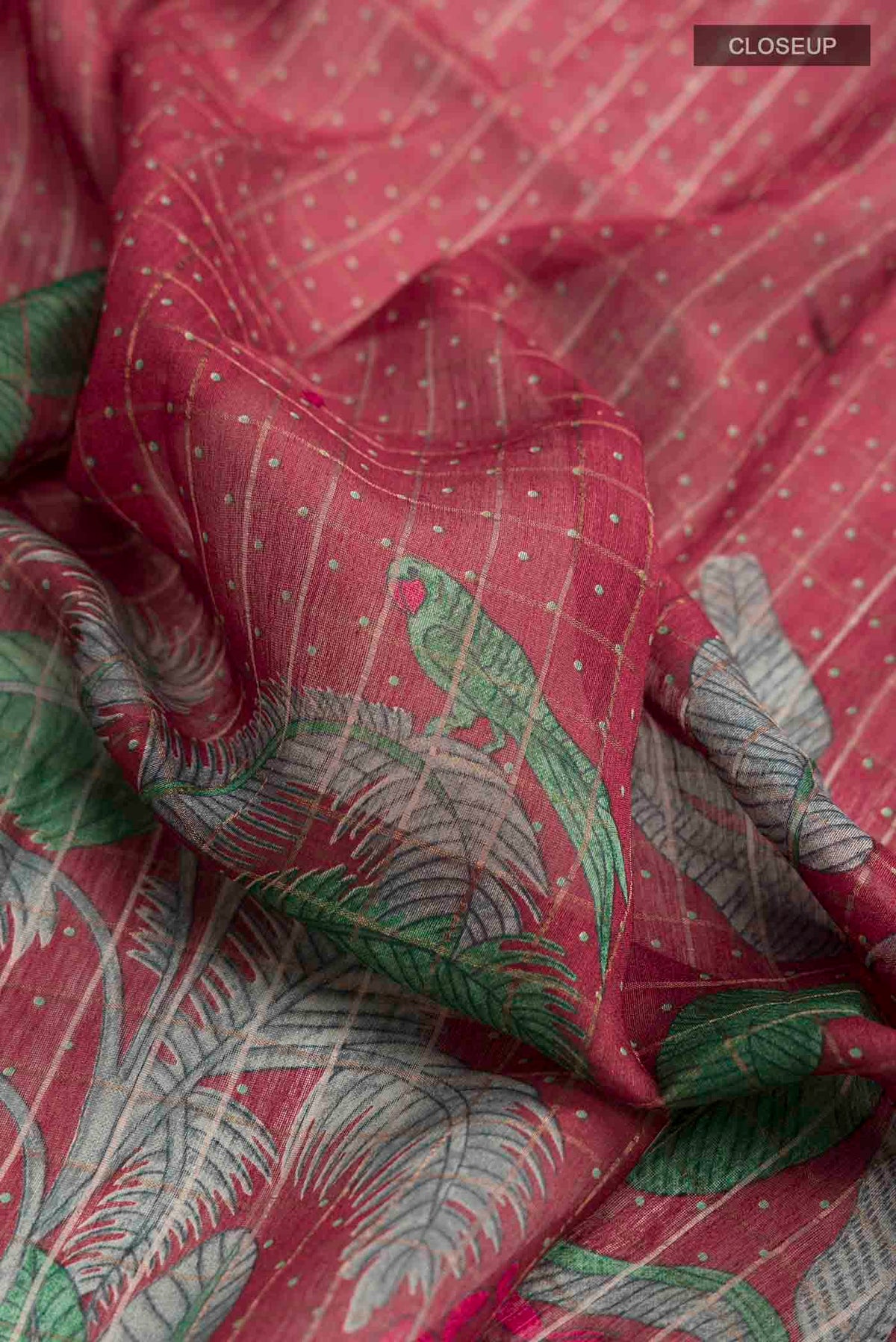 Close up of Maroon Bhagalpuri Tussar Silk Saree with Printed design on the body and Embroidery Border displaying folds