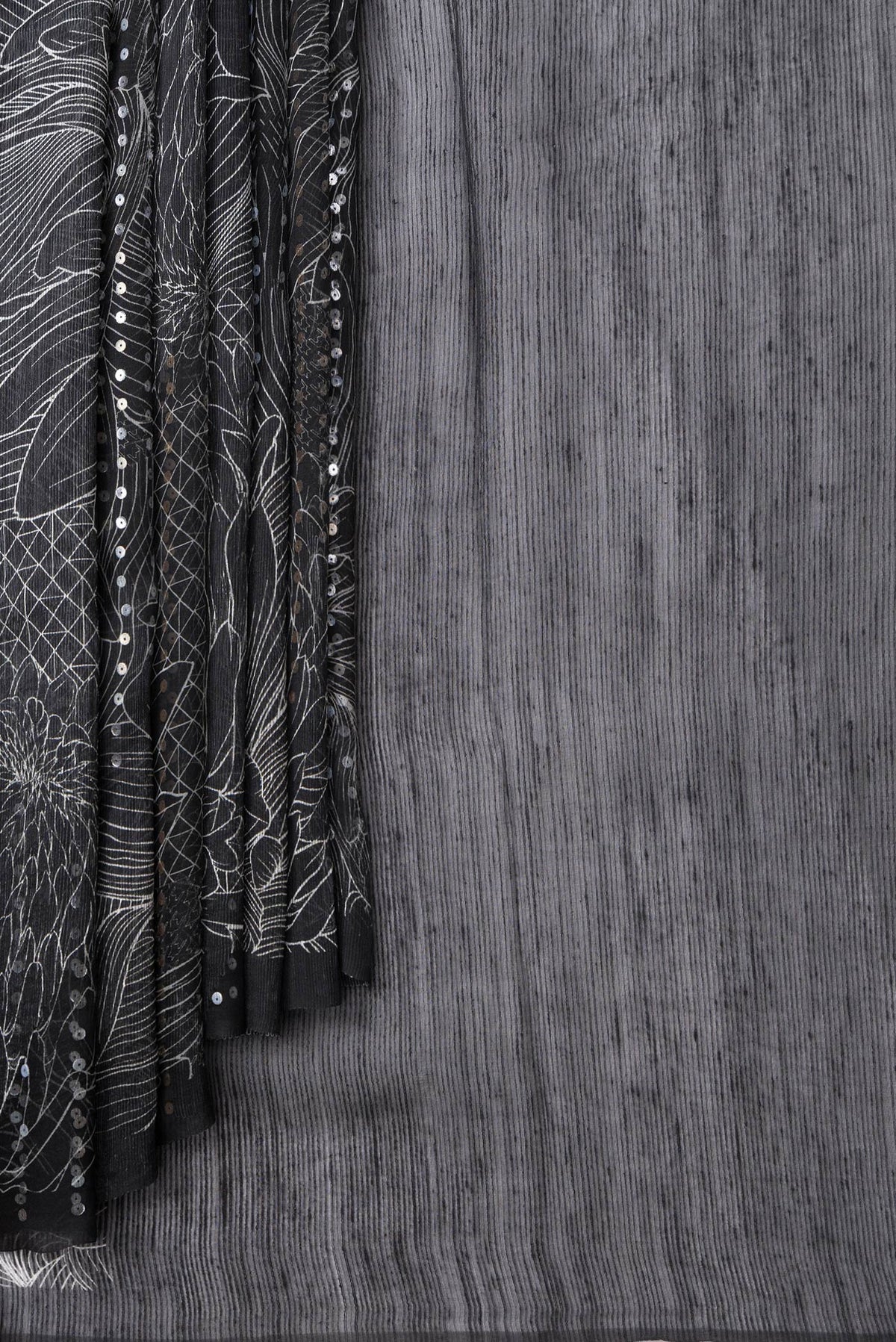 Pleats and pallu of Black Dual Tone Tussar Silk Saree with Printed design on the body and Without Border. 