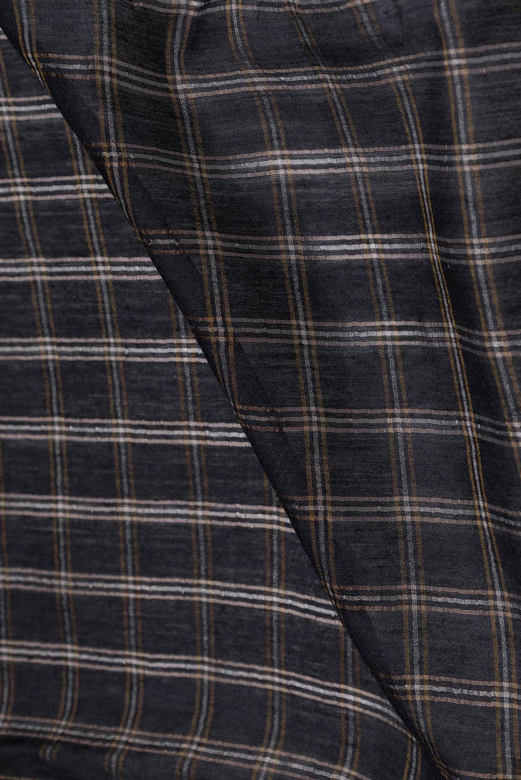 Close up of Black Tussar Silk Saree with Checked design on the body and Embroidery Border displaying folds