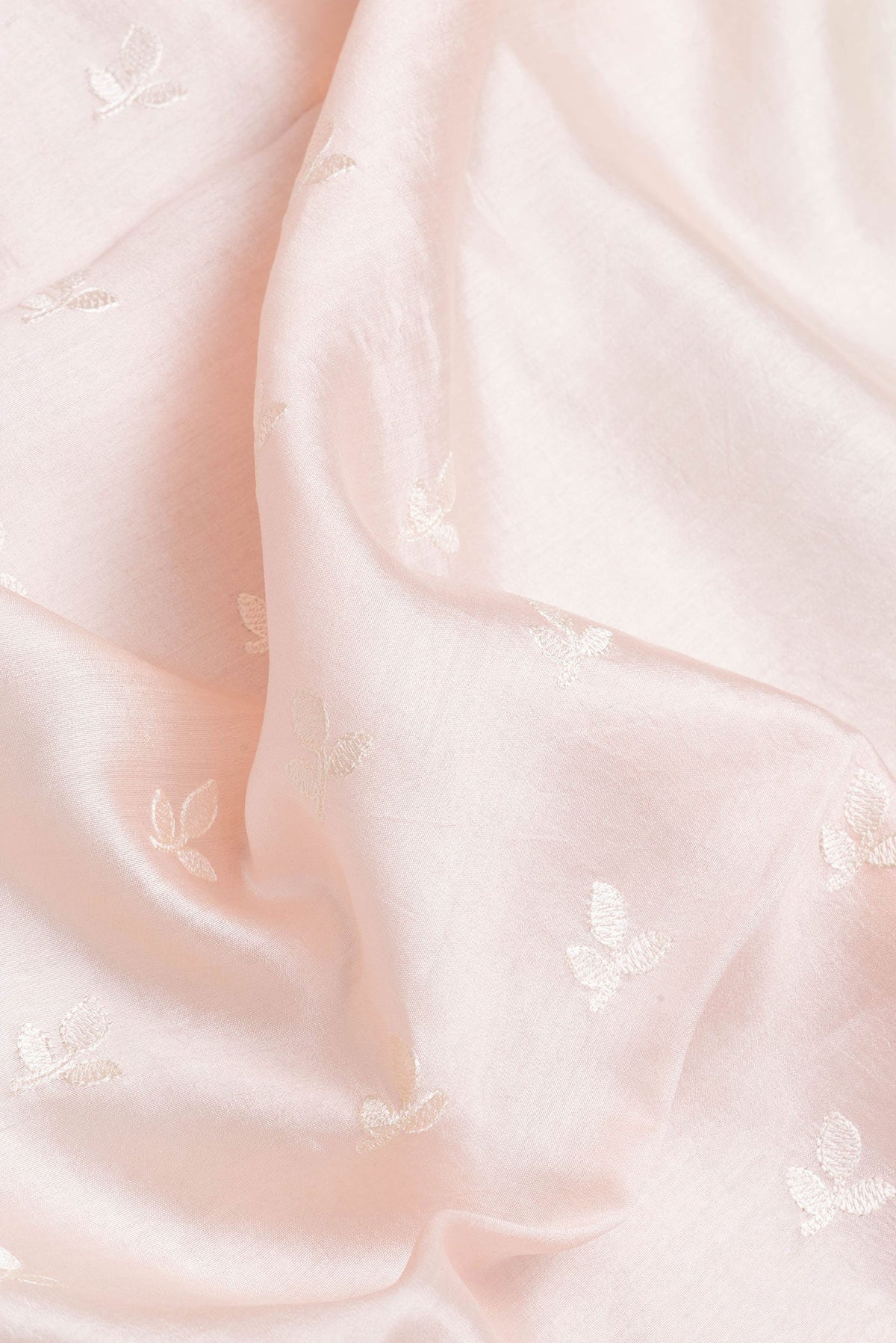 Close up of Rose Gold Dual Tone Tussar Silk Saree with Embroidery on the body and Zari Border.  displaying folds
