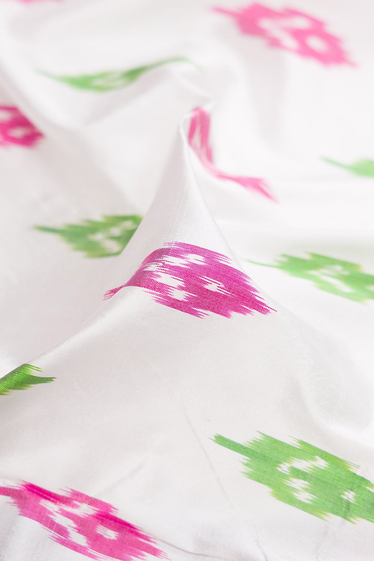 Close up of White Double Ikat Saree with Ikat Print on the body and Ikat Border.  displaying folds