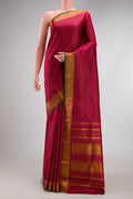 Maroon Kanchipuram Silk Saree with Stripes on the body and Zari Border.  displayed on a mannequin