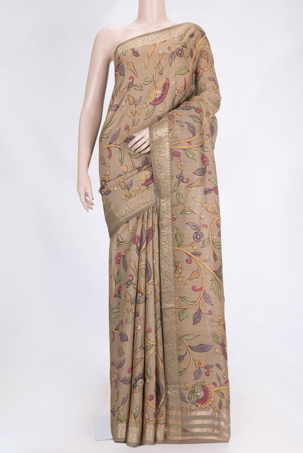 Beige Dual Tone Tussar Saree with kalamkari Print on the body and Zari Border.  displayed on a mannequin
