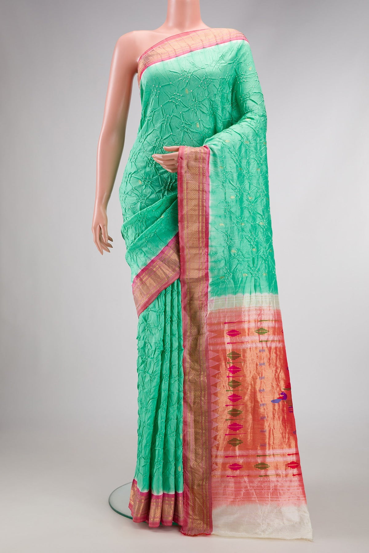 Sea Green Dual Tone Bandhani Silk Saree with Bandhani Print on the body and Zari Border.  displayed on a mannequin