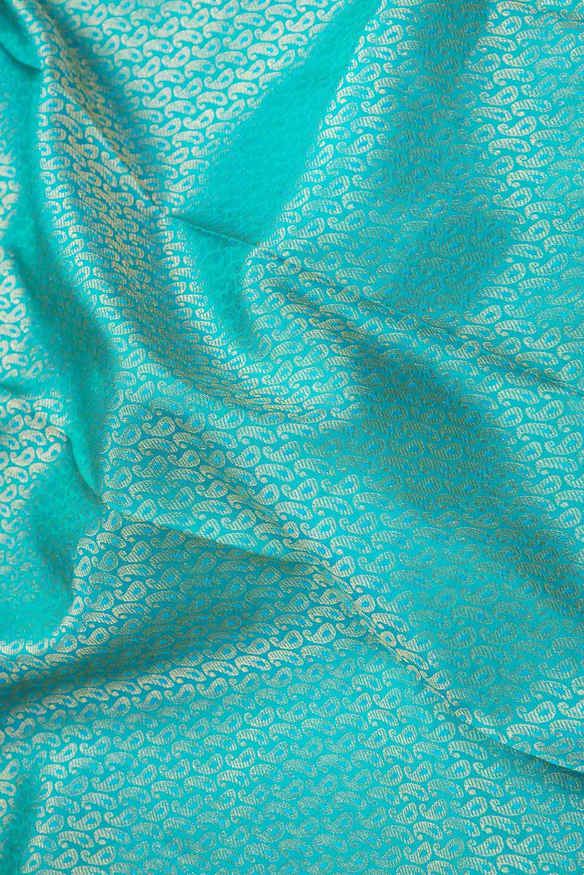 Close up of Pure Silk Pure Zari Green Dual Tone Kanchipuram Saree with Zari Brocade on the body and Zari Border displaying folds