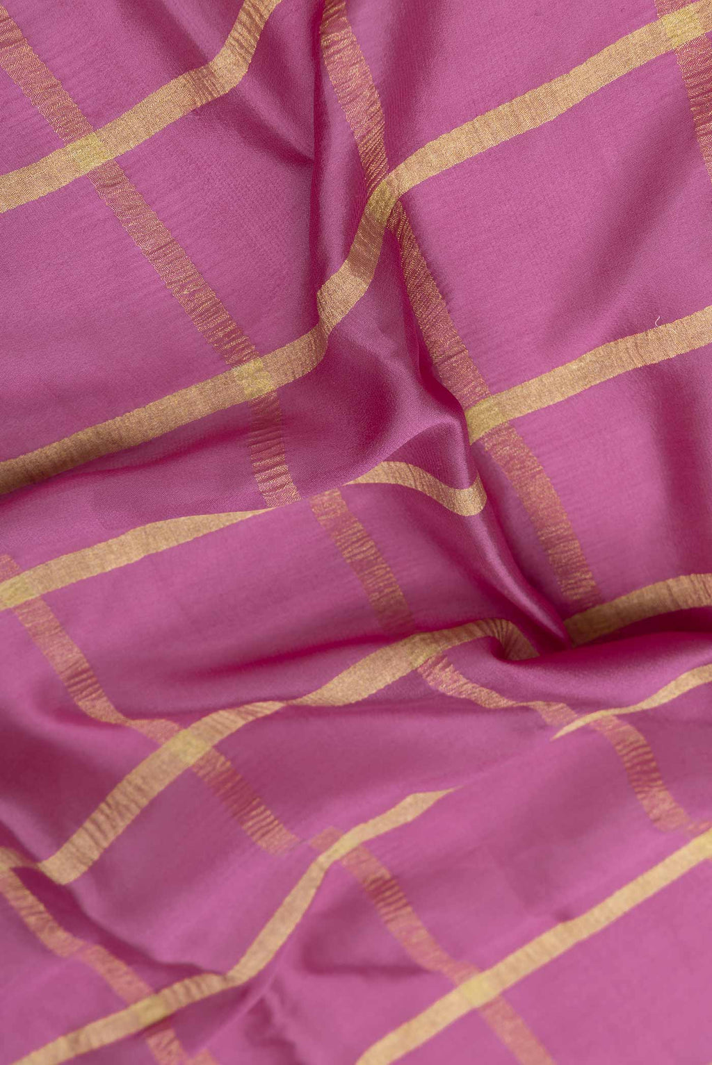 Close up of Light Magenta Mysore Crepe Saree with Checked design on the body and Zari Border displaying folds