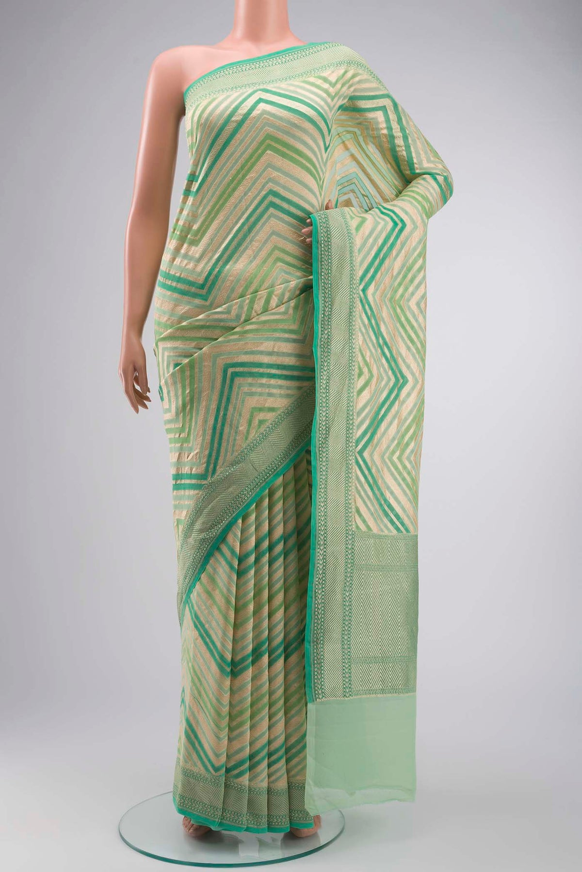 Green Banarasi Georgette Saree with Zari Butta on the body and Zari Border displayed on a mannequin