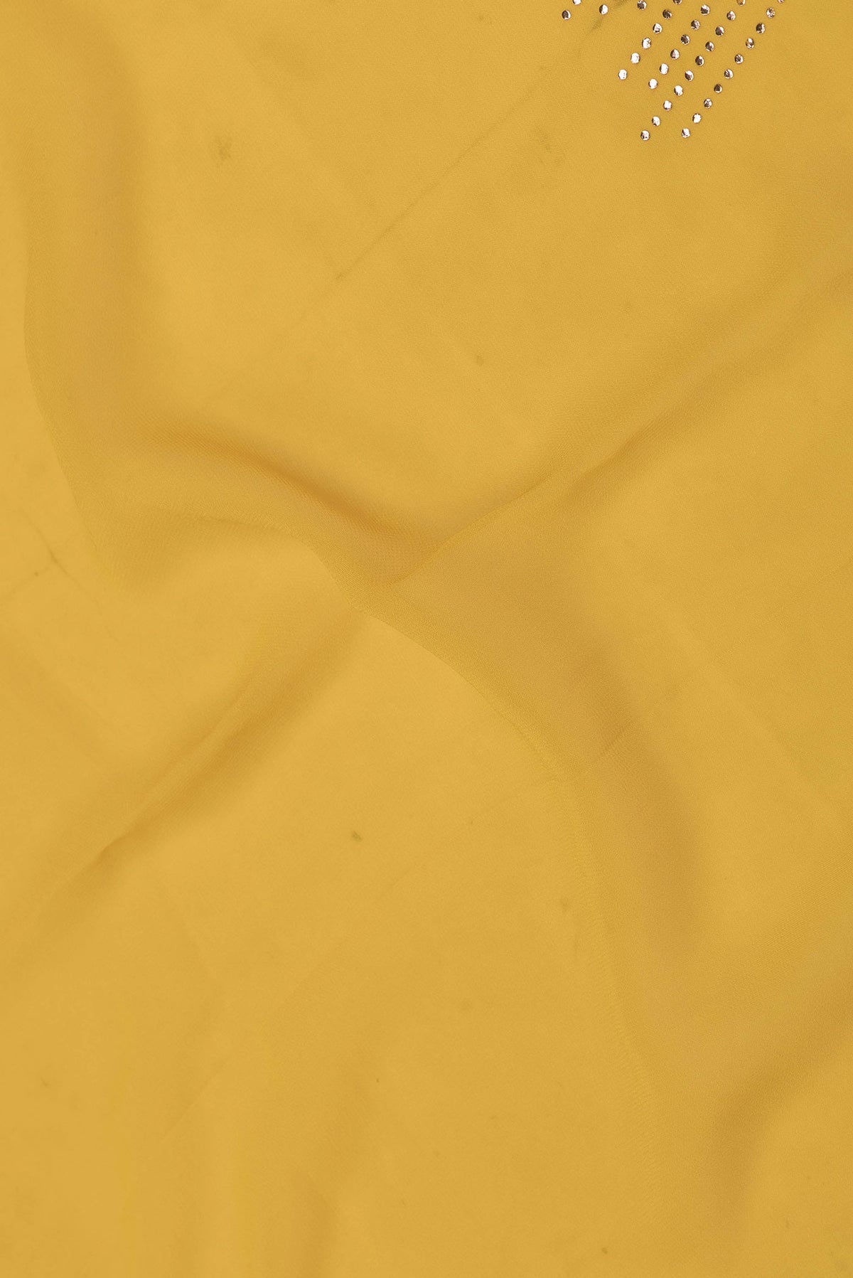 Close up of Yellow Dual Tone Georgette Saree with Embroidery on the body and Embroidery Border displaying folds