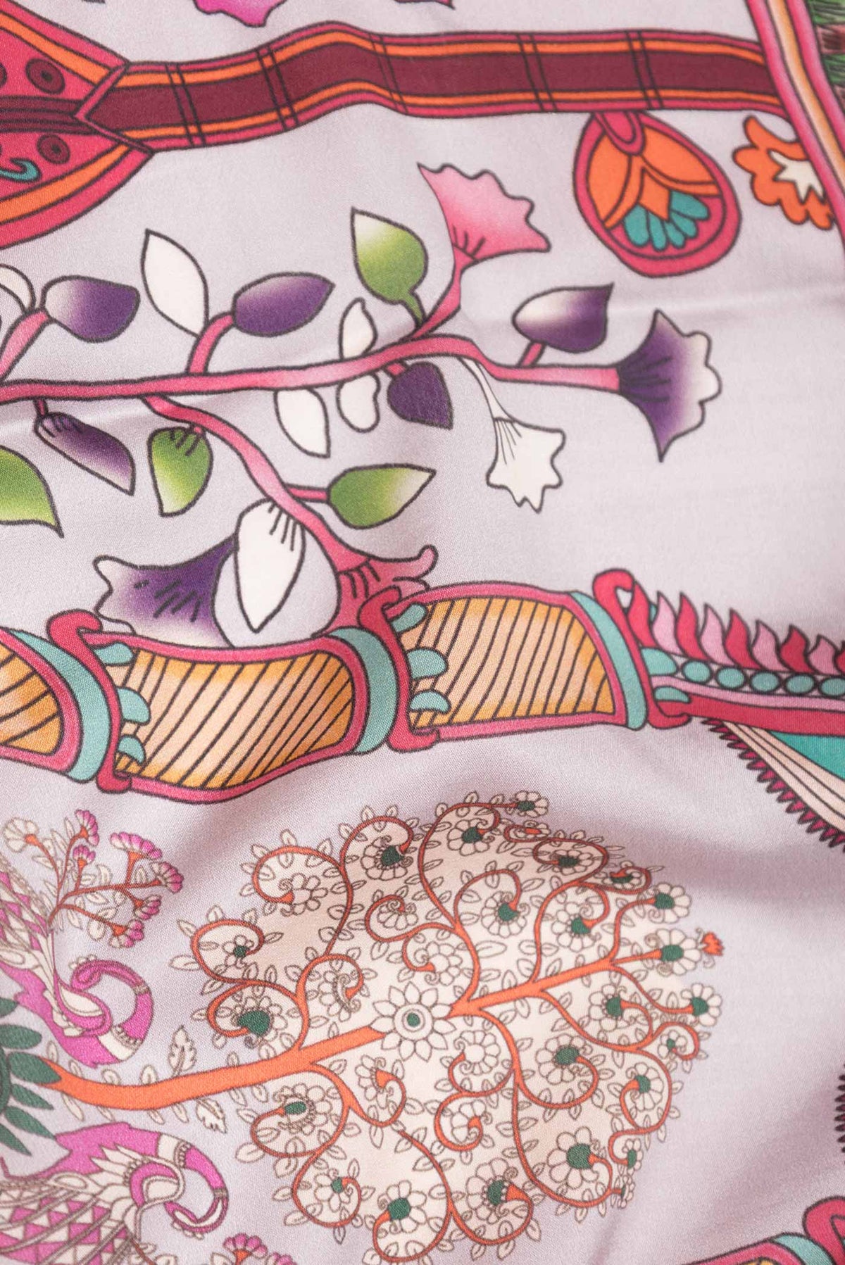 Close up of Rose Gold Dual Tone Mysore Crepe Saree with Printed design on the body and Zari Border displaying folds