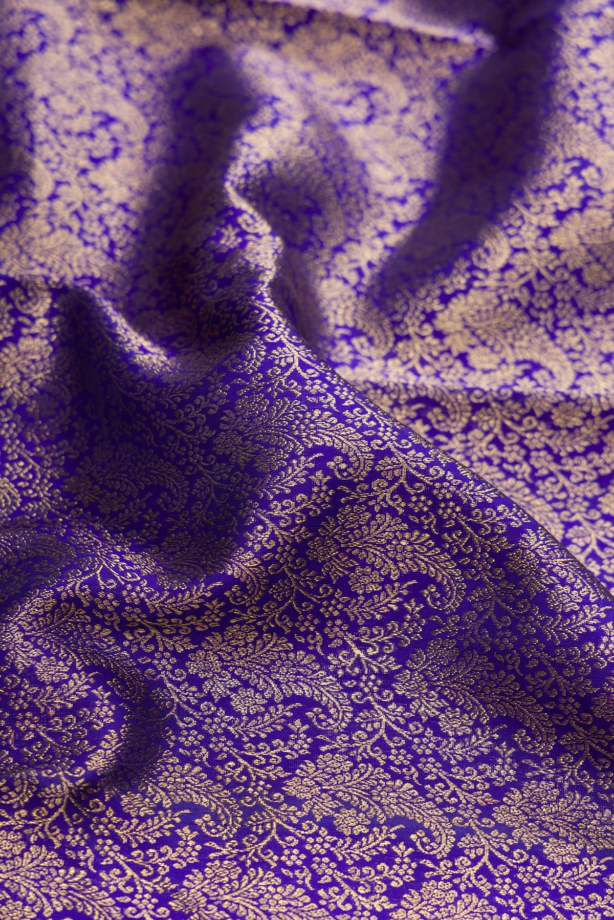 Close up of Pure Silk Pure Zari Royal Blue Dual Tone Kanjivaram Saree with Zari Brocade on the body and Zari Border.  displaying folds