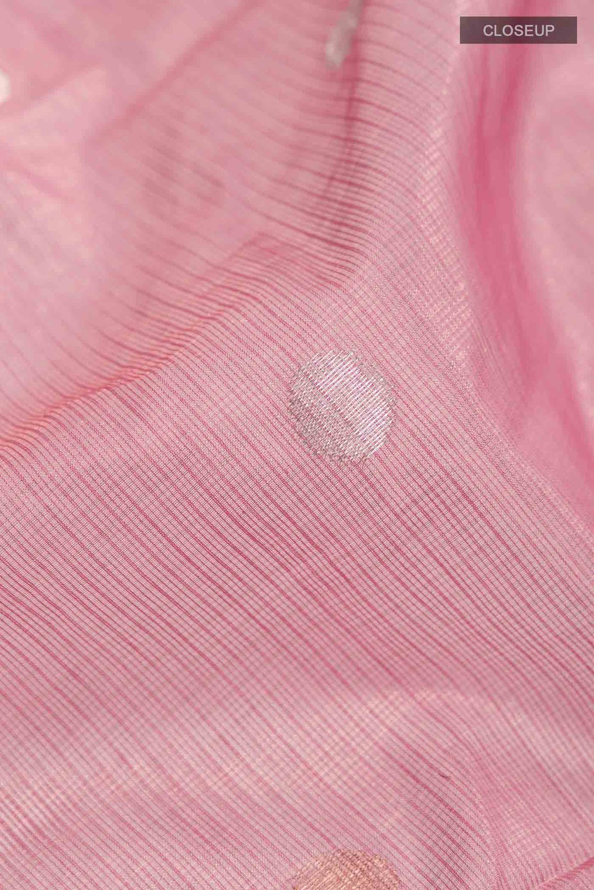 Close up of Pink Kota Silk Saree with Zari Butta on the body and Zari And Thread Border displaying folds