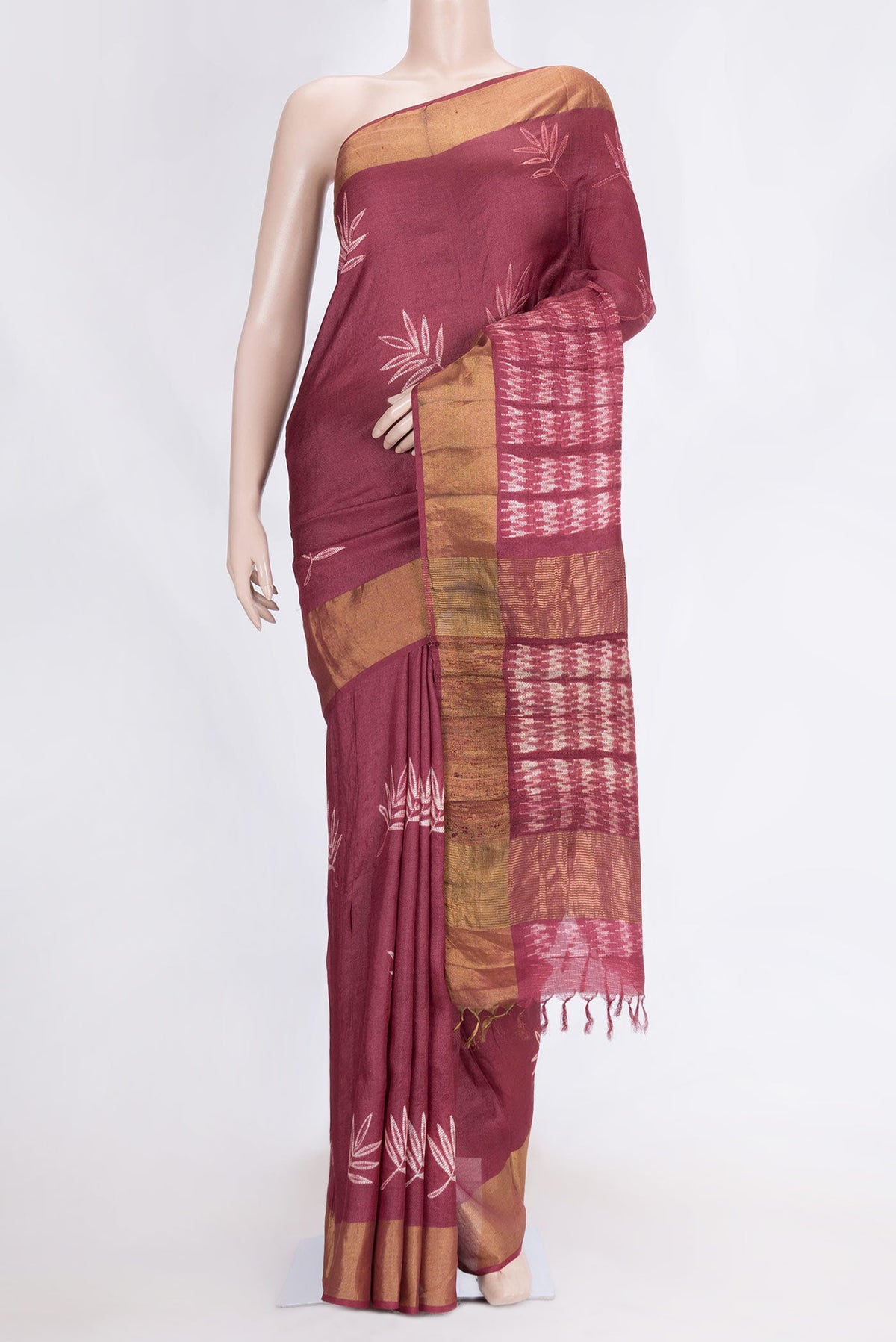 Maroon Dual Tone Tussar Saree with Printed design on the body and Zari Border.  displayed on a mannequin