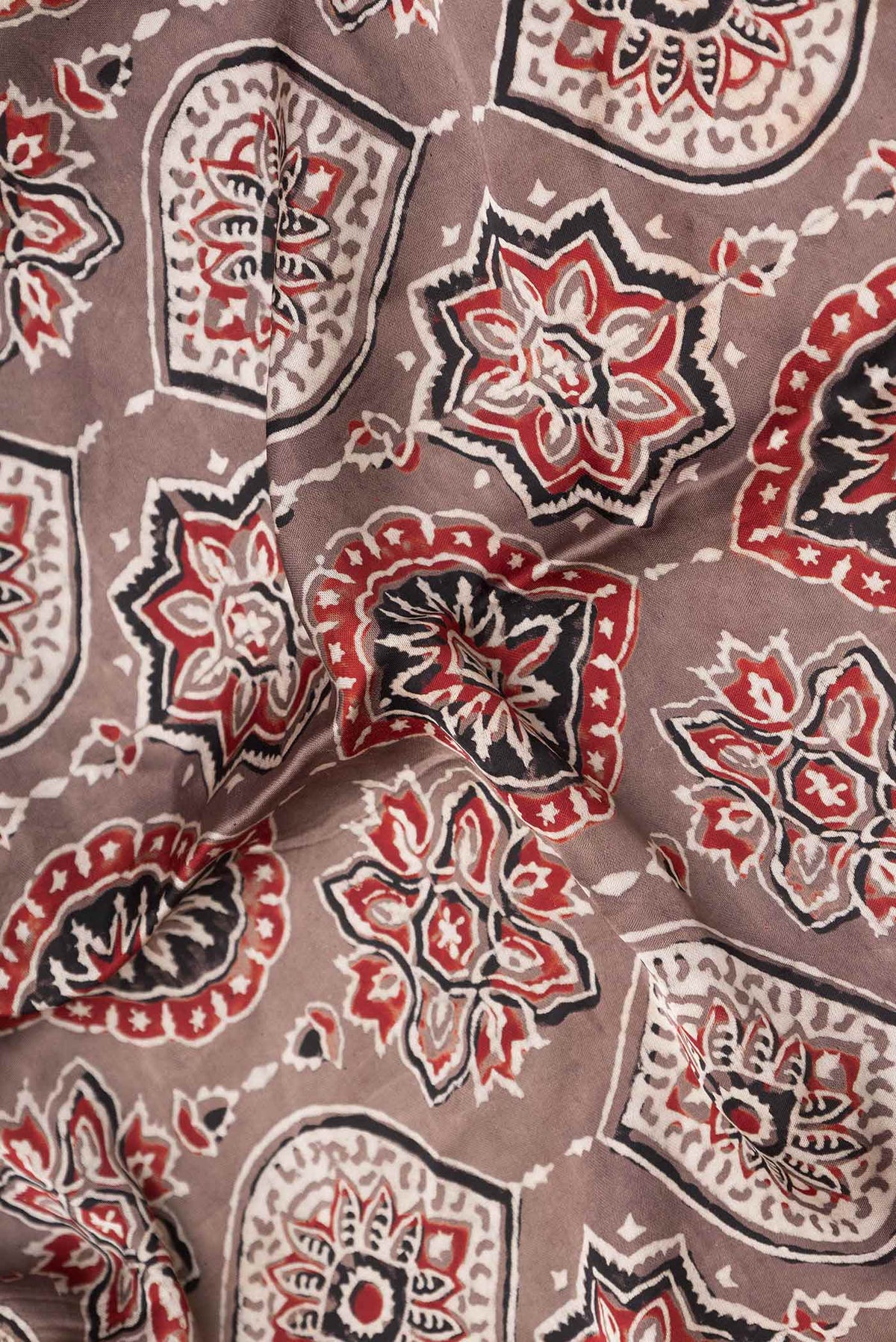 Close up of Brown Dual Tone Linen Saree with Printed design on the body and Zari Border displaying folds