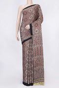 Brown Dual Tone Linen Saree with Printed design on the body and Zari Border displayed on a mannequin