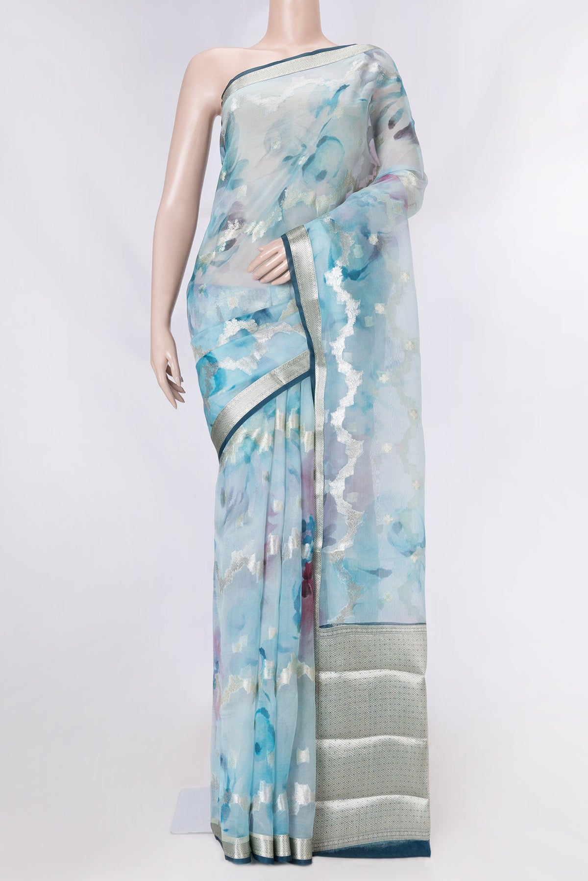 Sky Blue Dual Tone Organza Silk Saree with Zari Butta on the body and Zari Border displayed on a mannequin