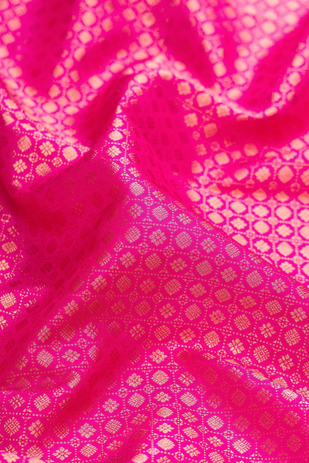 Close up of Pink Dual Tone Kanjivaram Silk Saree with Zari Brocade on the body and Zari Border.  displaying folds