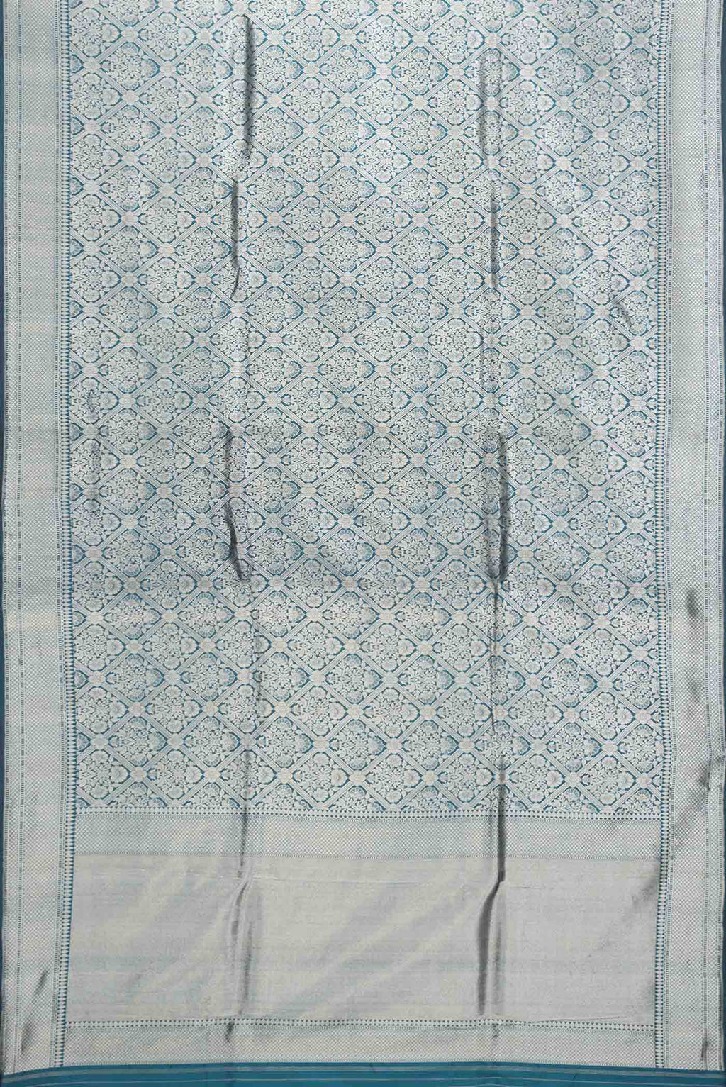 Flat view of Peacock Blue Dual Tone Banarasi Silk Saree with Zari Brocade on the body and Zari Border. 