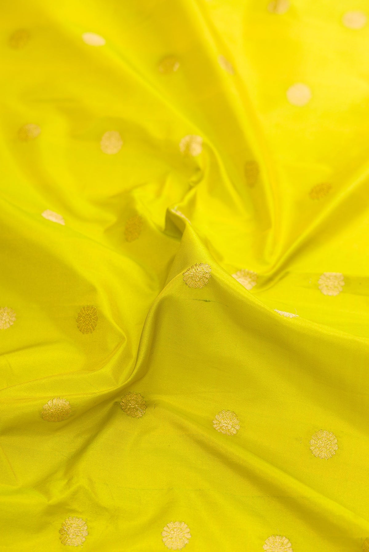 Close up of Parrot Green Dual Tone Paithani Silk Saree with Zari Butta on the body and Zari Border.  displaying folds