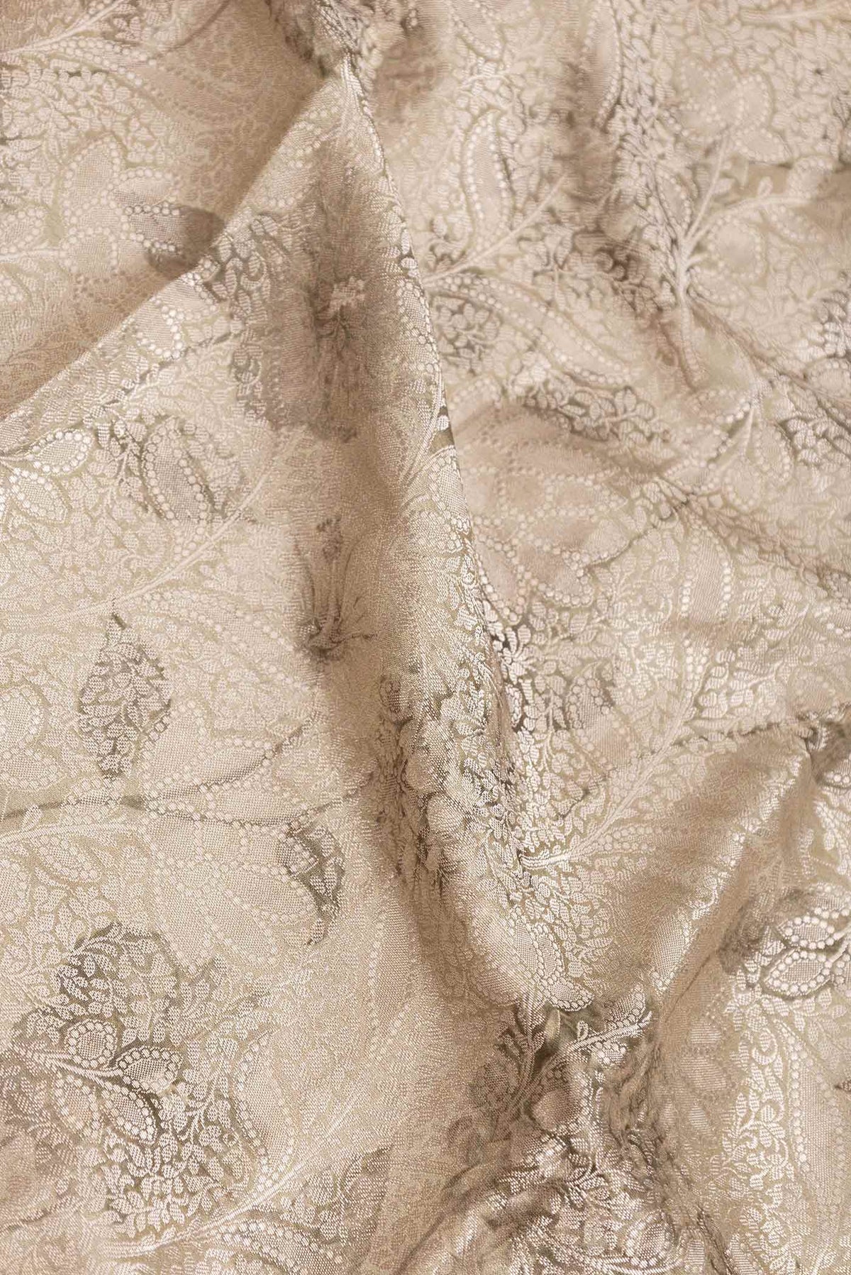 Close up of Beige Dual Tone Tussar Saree with Zari Brocade on the body and Fancy Border displaying folds