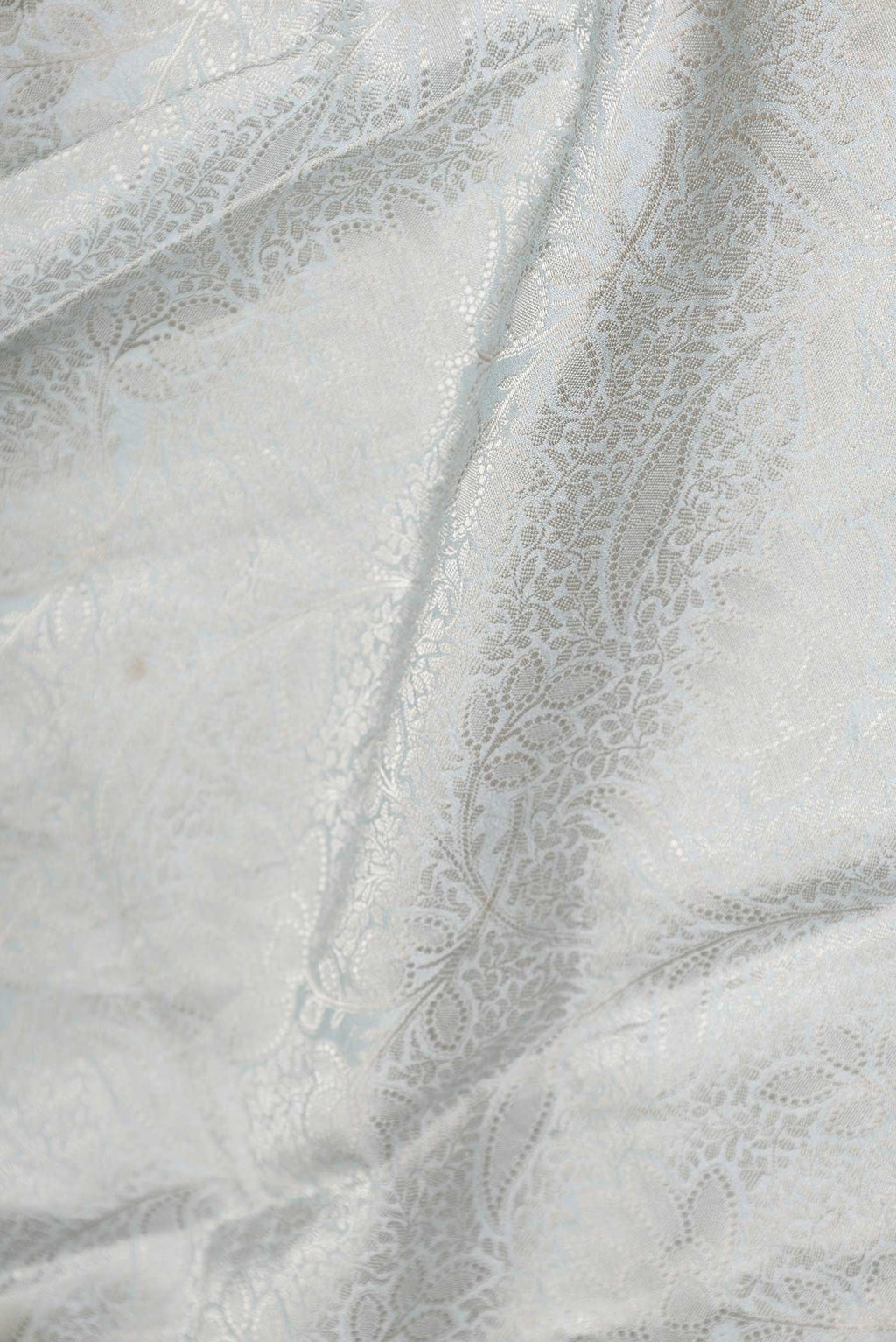 Close up of Grey Dual Tone Tussar Saree with Zari Brocade on the body and Fancy Border displaying folds