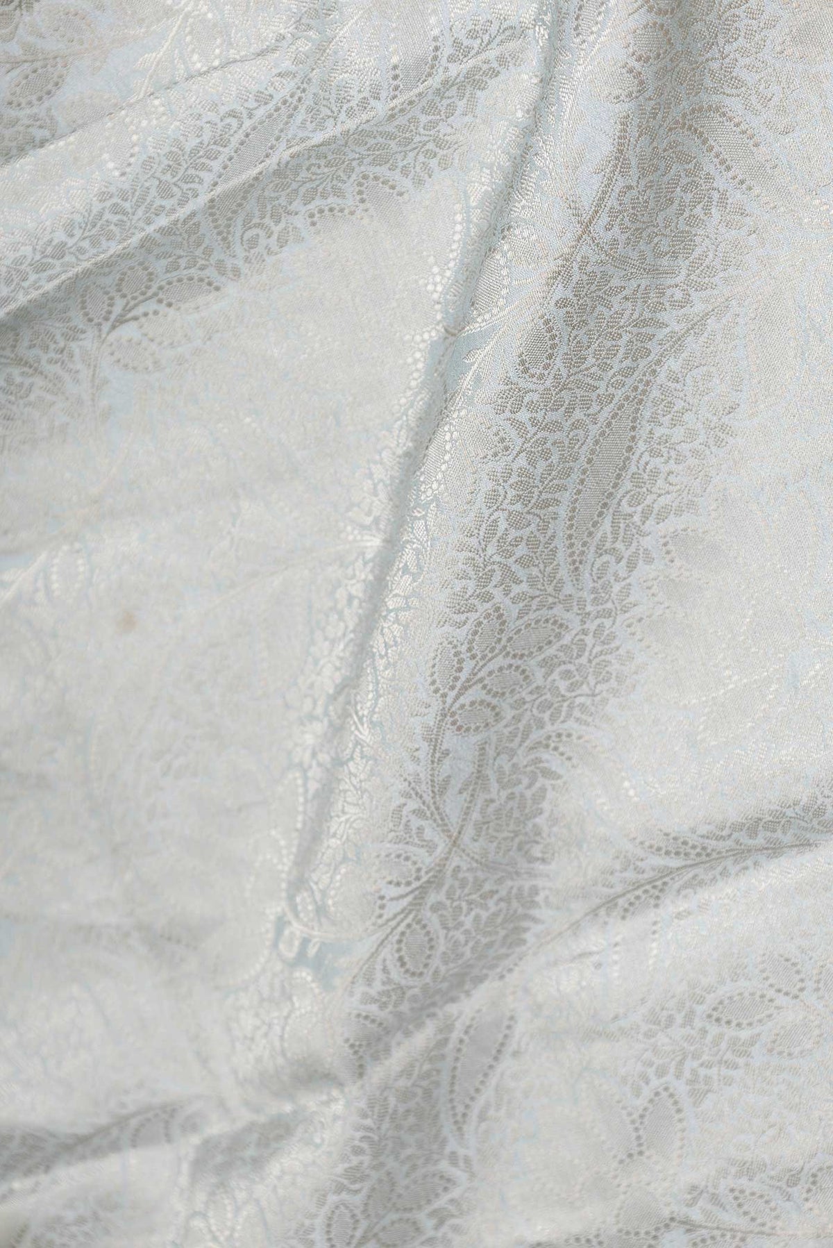 Close up of Grey Dual Tone Tussar Saree with Zari Brocade on the body and Fancy Border displaying folds