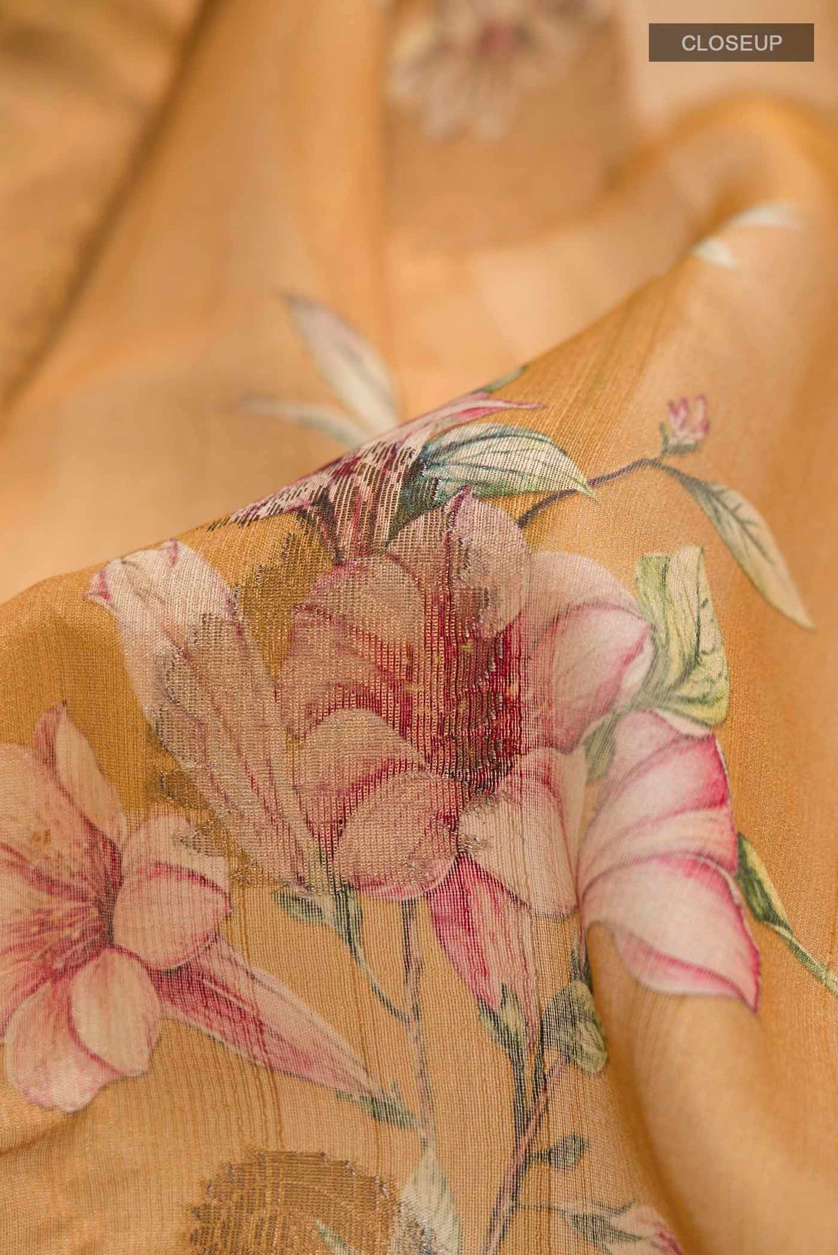Close up of Yellow Bhagalpuri Tussar Silk Saree with Printed design on the body and Zari Border displaying folds